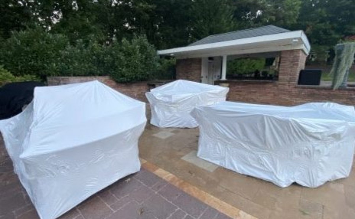 Patio furniture shrink wrapped for winter on a Nassau County patio — Clean N' Go Power Washing